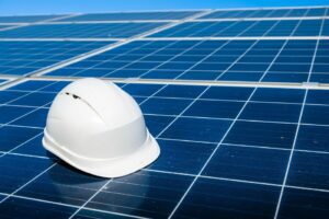 Image of a white hard hat on top of solar panels for solar panel Cleaning in Albuquerque